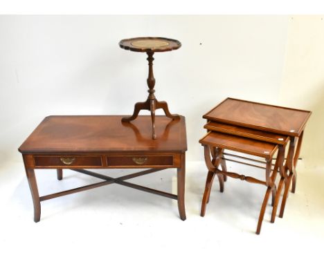 A reproduction mahogany coffee table with two base drawers, height 48cm, length 90cm, a reproduction nest of three graduated 