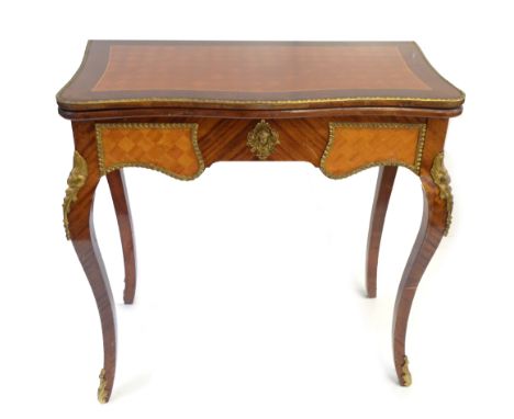 A reproduction French kingwood foldover card table with cast brass rim and applied panels, raised on cabriole supports, heigh