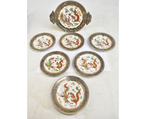 An Oriental porcelain part dinner set decorated in gilt and enamels with dragons chasing the sacred pearl, with reticulated w