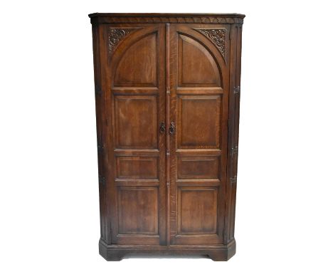 A reproduction carved oak hall robe with twin panelled doors, height 183cm, width 109cm, depth 46cm.Additional InformationLig
