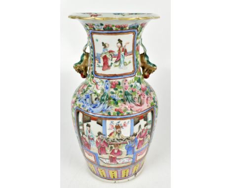 A 19th century Chinese Canton twin handled vase painted with stylised figures in panels inset within floral sprays, with reli
