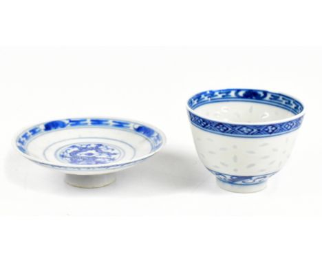 A Chinese 'rice inset' tea bowl painted with a floral spray to the centre and a shallow dish decorated with a dragon, both wi