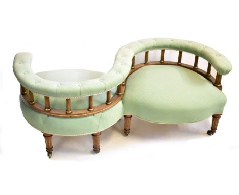 A Victorian walnut framed conversation or love seat with gilt and fluted detail in light green upholstery on tapered supports