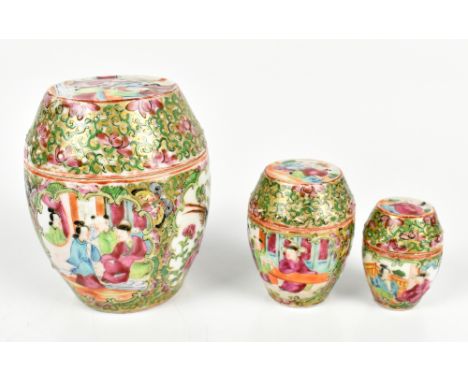 A graduated set of three early 20th century Chinese Canton lidded pots with painted figures inside panels and stylised detail