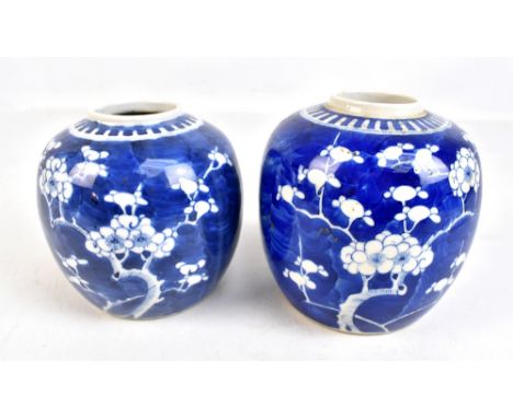 Two similar early 20th century Chinese blue and white prunus decorated jars, height 14cm and 13cm, both with painted double r