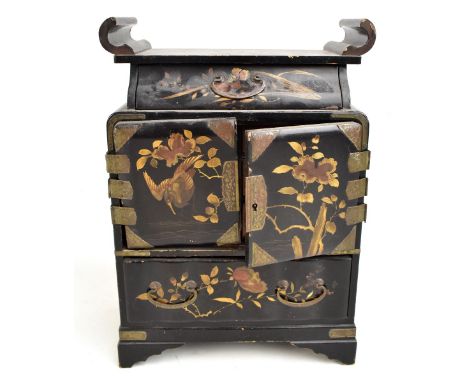 An early to mid-20th century Japanese lacquered jewellery cabinet with an arrangement of two drawers and two cupboard doors e