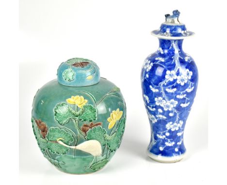 A late 19th century Chinese blue and white temple jar and cover painted with prunus flowers on a blue ground, four character 