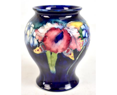 MOORCROFT; an 'Orchid' pattern baluster vase with blue ground, painted and impressed marks to the base, height 14.5cm.Additio