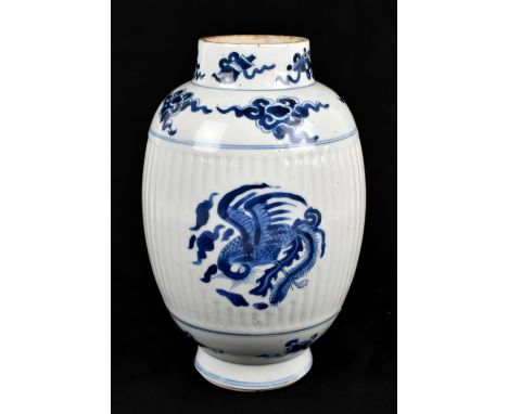 An 18th century Chinese porcelain blue and white vase, painted with phoenix on a ribbed body, the rim featuring Buddhist prec