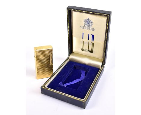 DUNHILL; a boxed gold plated vintage lighter of rectangular form with engine turned decoration, height 6cm.Additional Informa