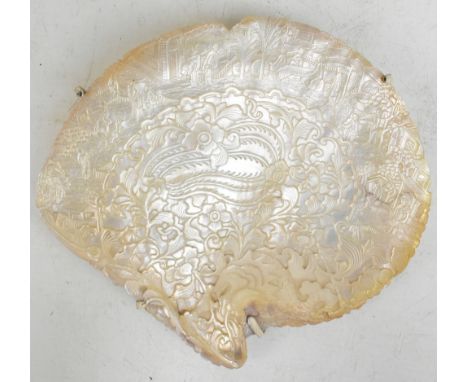 A 19th century Chinese carved mother of pearl plaque, the outer border decorated with figures and animals in a landscape, the