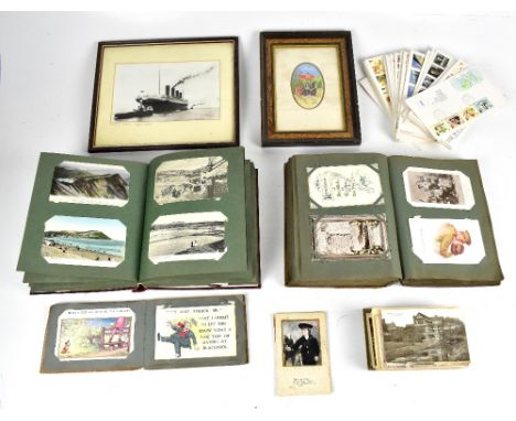 Two early to mid-20th century predominantly topographical postcard albums, a reprinted photograph of the Titanic, a Cash silk