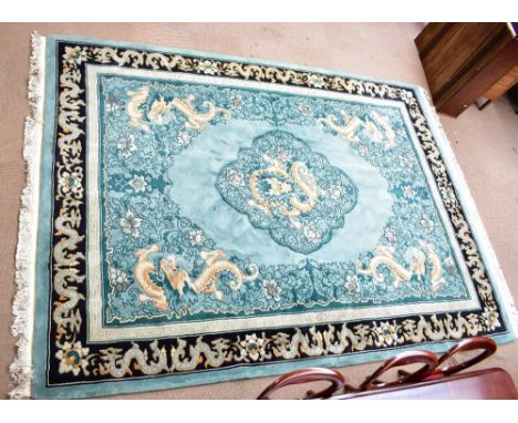 A large green ground Chinese Superwash carpet decorated with dragons, approx 375 x 280cm.