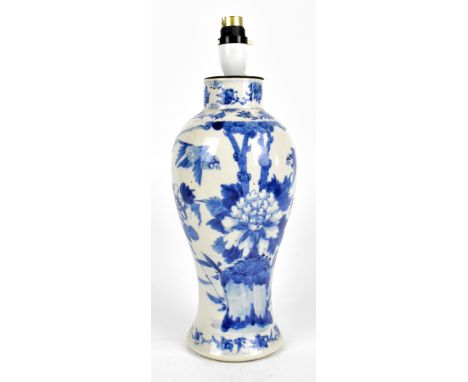 An early 20th century Chinese blue and white porcelain vase converted to a lamp base painted with exotic birds and floral spr