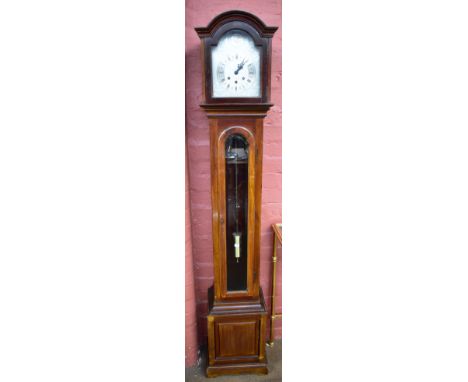 A 1920s/30s mahogany grandmother clock with bevelled glazed door beneath silvered dial set with Roman numerals to the chapter