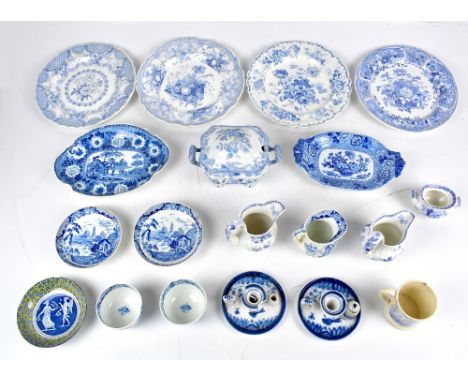 A group of 19th century transfer decorated blue and white ceramic tableware, including sauceboats, mugs, cups, chamber stick,