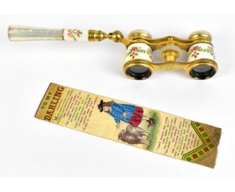 A pair of early 20th century French brass and mother of pearl handled opera glasses with enamelled floral decoration (af) and