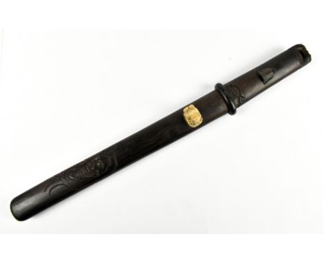 A good Japanese Meiji period hardwood doctor's accutchi with carved detail featuring ascetic monk, floral and stylised device