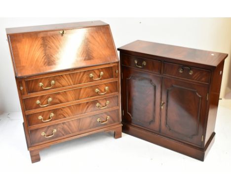 A reproduction mahogany bureau with fall front above four graduated drawers, width 75cm, and a reproduction side cabinet with