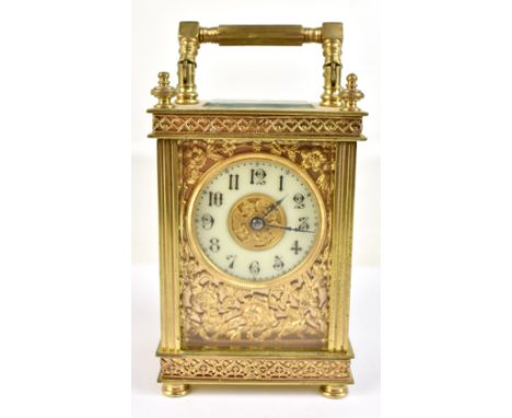 A 19th century French brass carriage clock with applied floral detail, circular dial with Arabic numerals, height including s