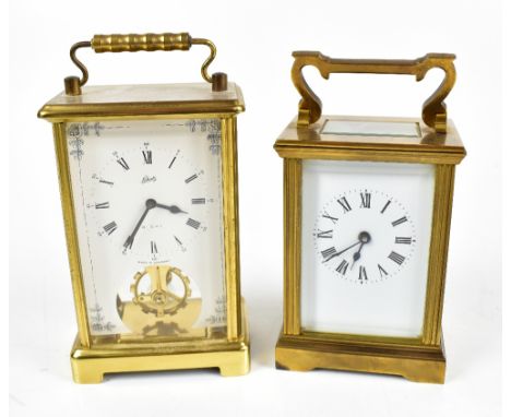 An early 20th century French brass carriage clock with white enamel dial set with Roman numerals, with swing loop handle, hei
