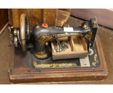 A CASED VINTAGE SEWING MACHINE