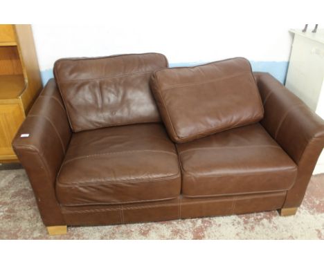 A BROWN TWO SEATER SOFA