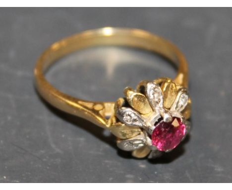 AN UNUSUAL LADIES 'FLOWER' RING WITH CENTRAL RUBY AND DIAMOND ACCENTS
