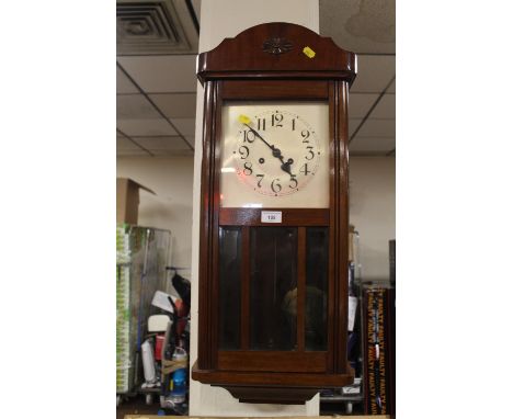 AN OAK CASED WALL CLOCK