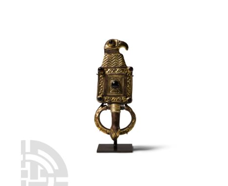 Late 6th-early 7th century A.D.. Comprised of a crescent loop with bird-head finials, punched-point detailing and cloison eye