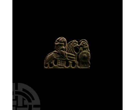 Circa 9th century A.D.. Openwork plate brooch or mount with two pierced lugs to the reverse depicting a rider and standing fi