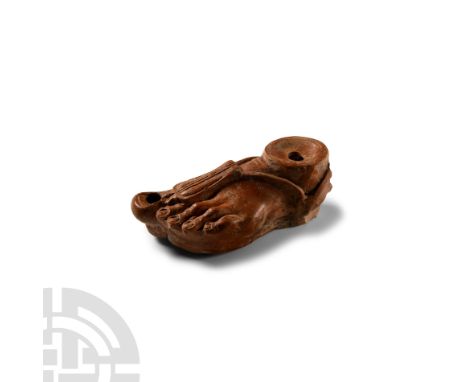 2nd century A.D.. Mould-made and shaped as a sandaled left foot, filling-hole surrounded by a ridge in the ankle area, the sa