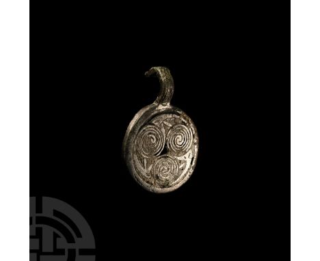 Circa 6th-7th century A.D.. Discoid and hollow to the reverse with raised rim and shallow suspension hook with beast-head fac