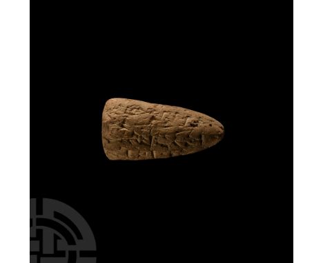 Circa 3rd millennium B.C. Conical in form with facetted faces bearing cuneiform text. See Aruz, J., Art of the First Cities. 