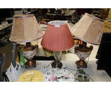 A pair of table lamps and shades, and a brass and glass table lamp with shade