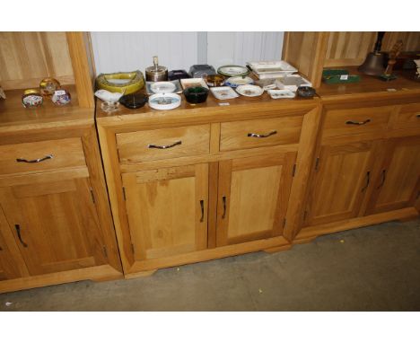 A modern light oak side cupboard fitted two drawers above 