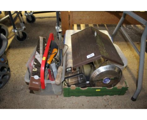 A plastic tray of various tools together with a bird feeding station and various bird feeds