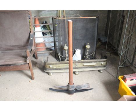 A pick axe and handle with spare mattock head