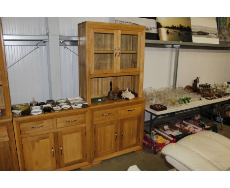 A modern light oak glazed cabinet fitted two drawers and cupboard below