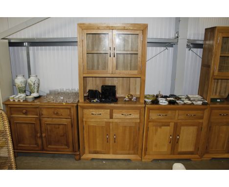 A modern light oak and glazed cabinet fitted two drawers and cupboard below