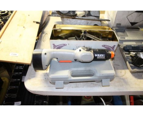 A Black and Decker cordless sander lacking charger, together with a case of various attachments