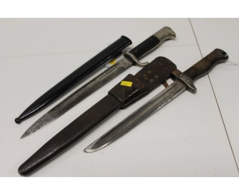 Nazi dress bayonet with plated bird's head pommel, black plastic grips, fullered blade, in black painted scabbard