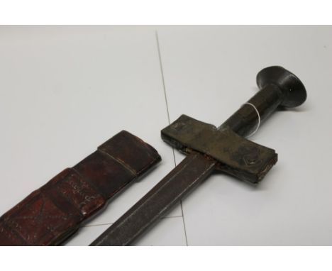 Late 19th century Sudanese sword with brass barrel cruciform hilt, European blade in tooled leather scabbard, 94cm overall