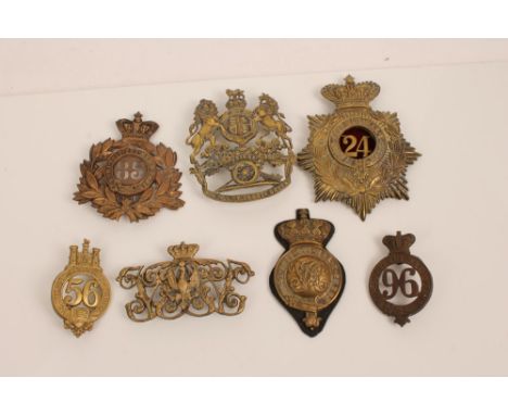 Collection of seven Victorian and later helmet plates, including Royal Artillery