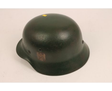 Nazi M35 helmet with single decal and green painted camouflage and leather lining, together with a German First Aid case (2)