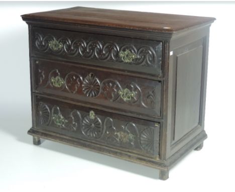 An unusual early 18th Century carved English Provincial oak Chest, the moulded top over three long drawers with carved fronts