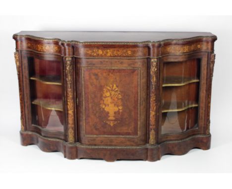 A large and impressive 19th Century English walnut Credenza, the shaped top with ormolu edge, inlaid frieze over a panel door