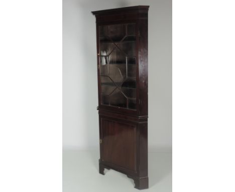 A good quality Georgian style Corner Cabinet, with astragal glazed door, the Greek key moulded cornice on panel door base wit