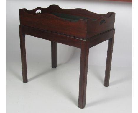 A heavy Chippendale style mahogany Butlers Tray, with pierced handles, on a matching stand, with square chamfered legs, 73cms