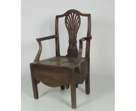 A late 18th Century Chippendale style oak Commode Armchair, with carved pierced splat back, on square legs. (1)